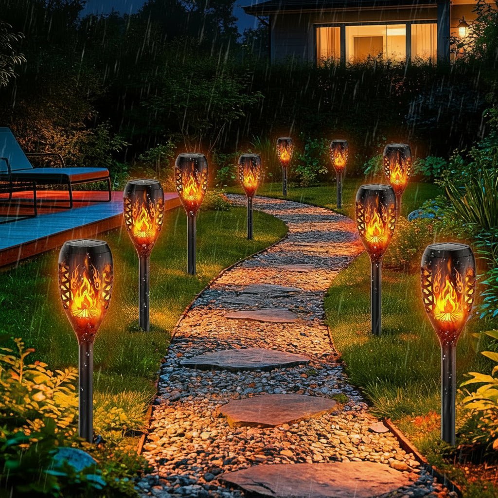 Outdoor solar pathway lights beside a flower border